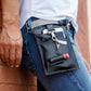 A black and gray vegan leather phone pouch with a black vegan leather magnetic wristlet key chain and a black and gray removable three pocket wallet used as a fanny pack belt bag. 
