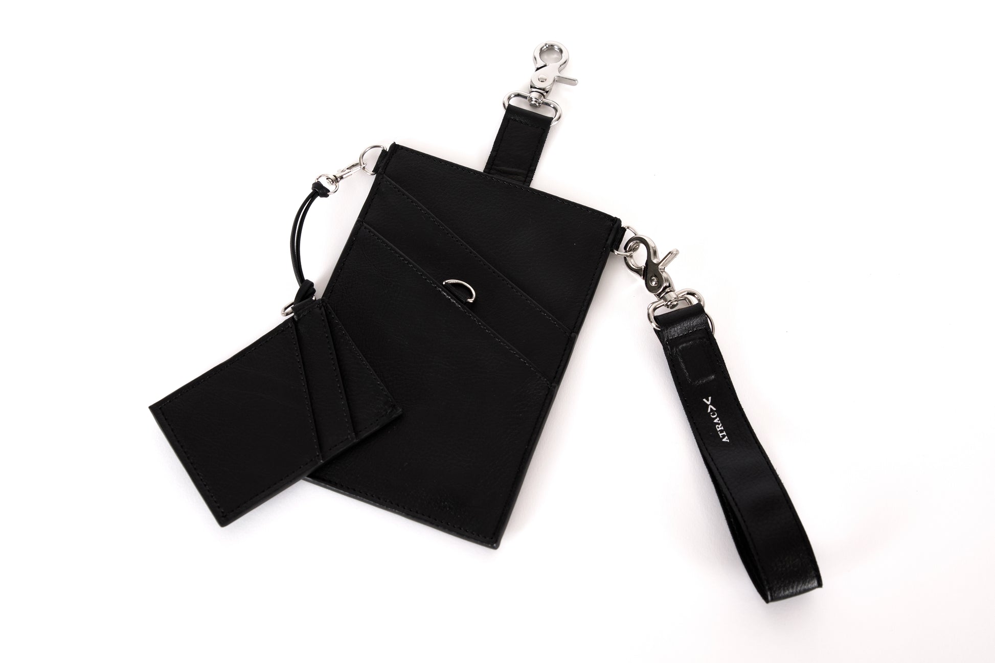 A black vegan leather phone pouch with a black vegan leather magnetic wristlet key chain and a black removable three pocket wallet.